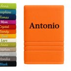 Personalisiertes badehandtuch 100% baumwolle in orange mit name antonio bestickt in schwarzem faden