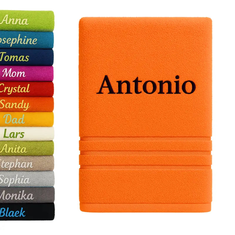 Personalisiertes badehandtuch 100% baumwolle in orange mit name antonio bestickt in schwarzem faden