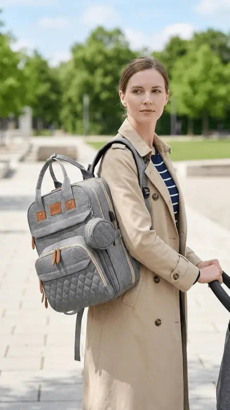 Grauer grovy eltern-rucksack mit gesteppter struktur und braunen lederakzenten als multifunktionale wickeltasche online bestellen